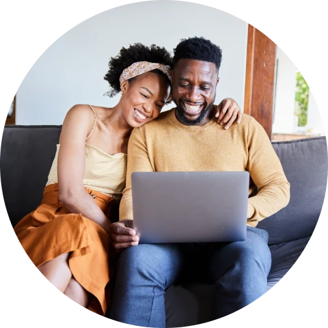 Happy pair using laptop together