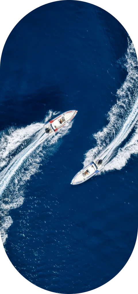 Boats racing on deep blue water